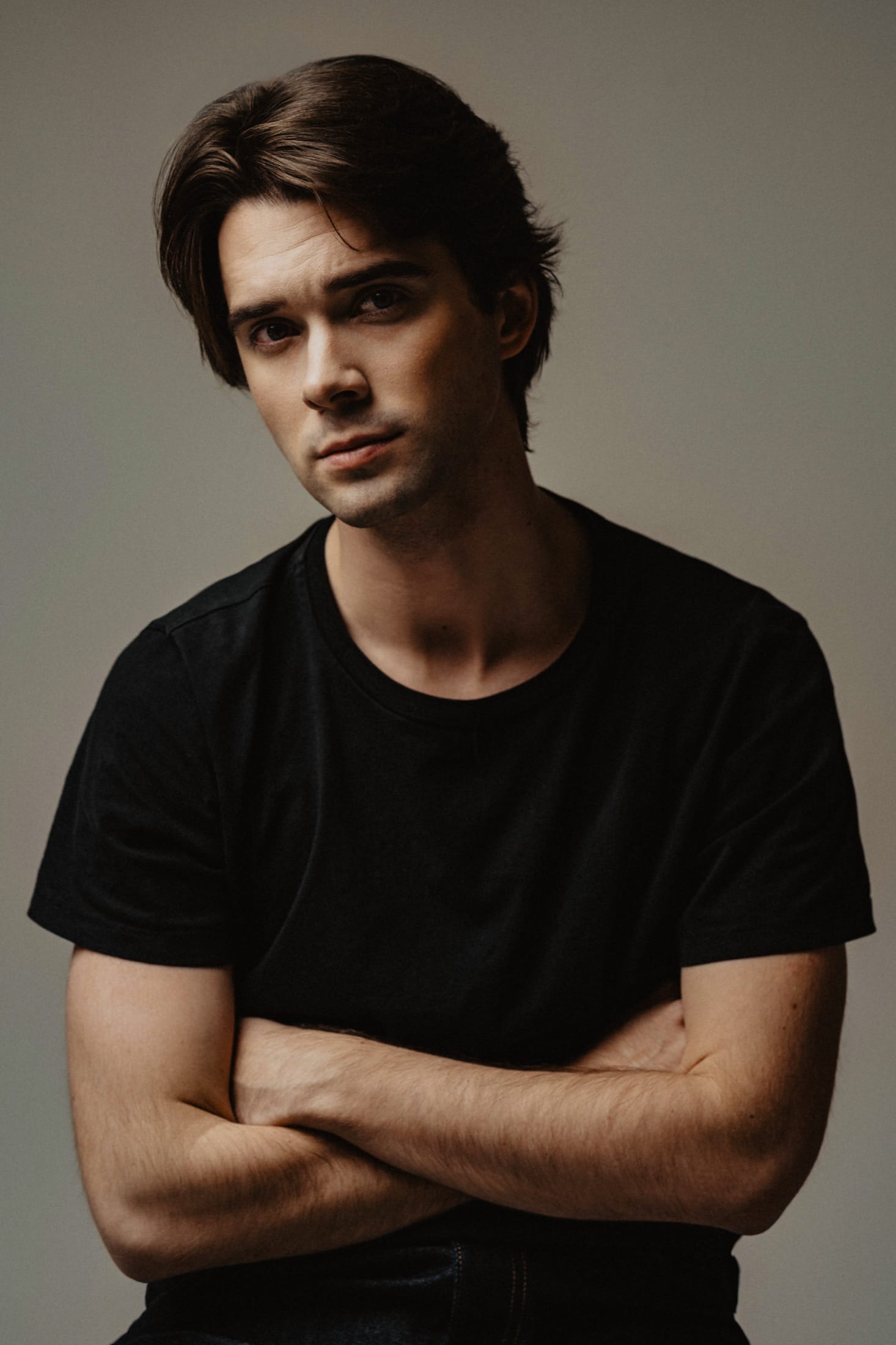 Headshot, arms crossed, black t-shirt